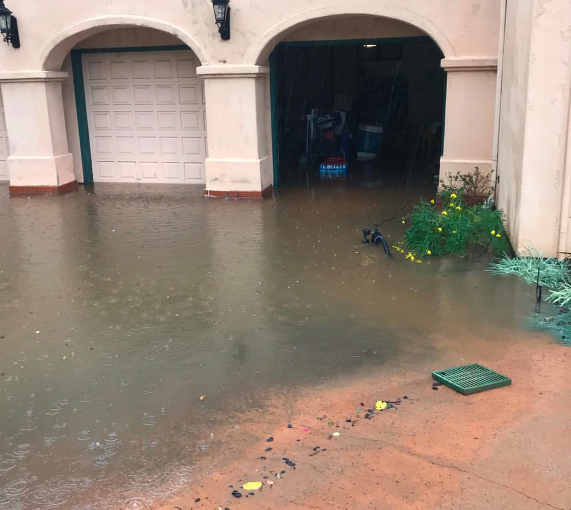 Flooded driveway from storm drains